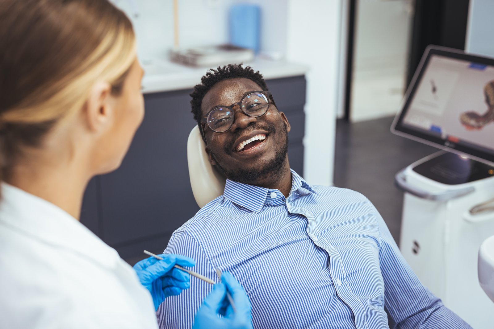 Dentist and patient during a routine dental exam and cleaning